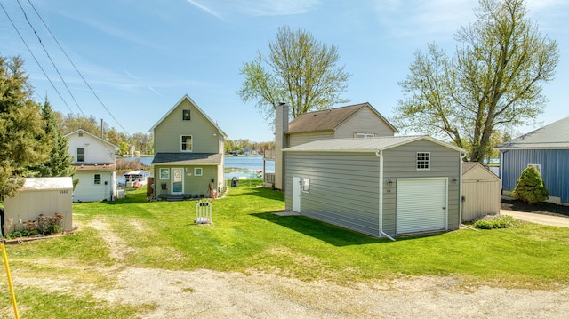 5576 Rays Dr, Onsted, MI 49265 - back of house featuring a lawn, an outbuilding, a shed, and a chimney
