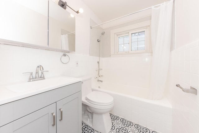 1324 Wells St, Ann Arbor, MI 48104 - full bathroom with vanity, toilet, tile walls, tile patterned floors, and shower / bath combo