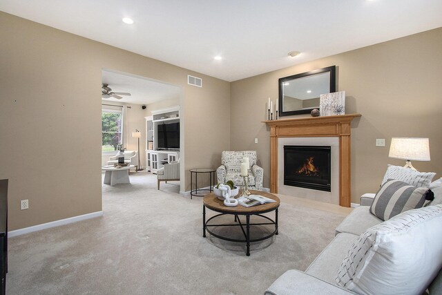 2191 W Linco Rd, Stevensville, MI 49127 - living room with a lit fireplace, baseboards, light carpet, recessed lighting, and ceiling fan