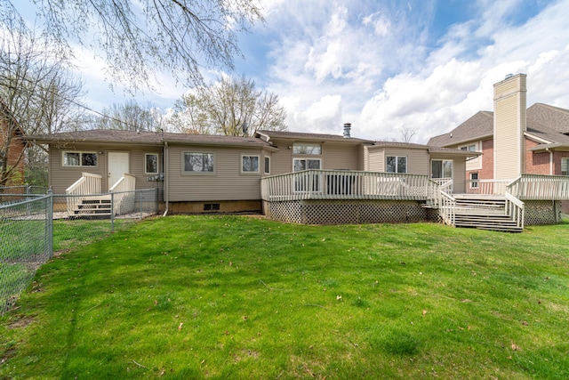 back of house with fence, a yard, and a wooden deck