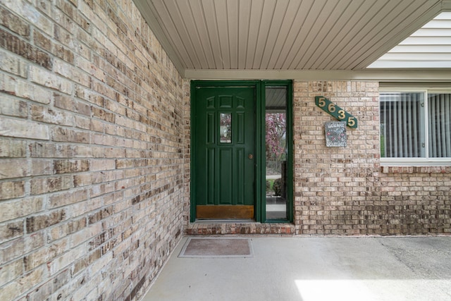 entrance to property with brick siding
