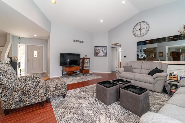 living area featuring visible vents, wood finished floors, baseboards, high vaulted ceiling, and recessed lighting