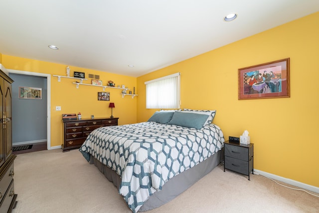 bedroom with baseboards, recessed lighting, and light colored carpet