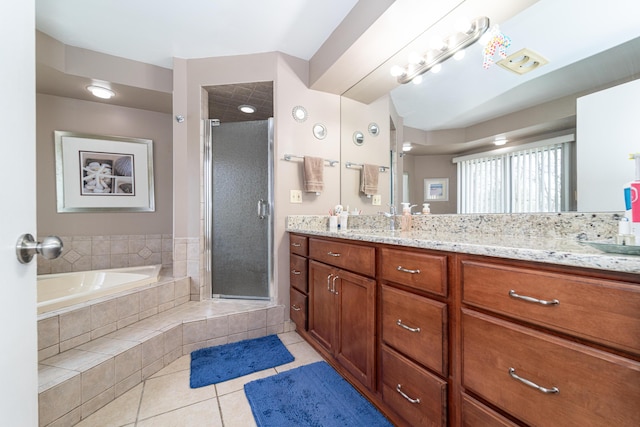 full bath with vanity, tile patterned flooring, a shower stall, and a bath