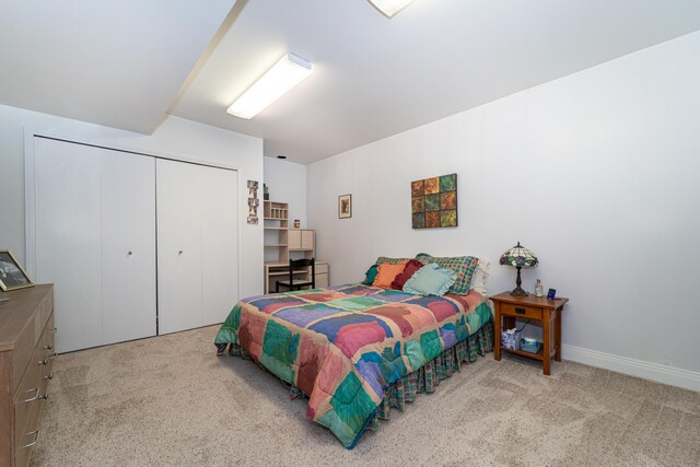 bedroom with carpet floors, baseboards, and a closet