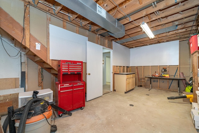 unfinished basement with a workshop area