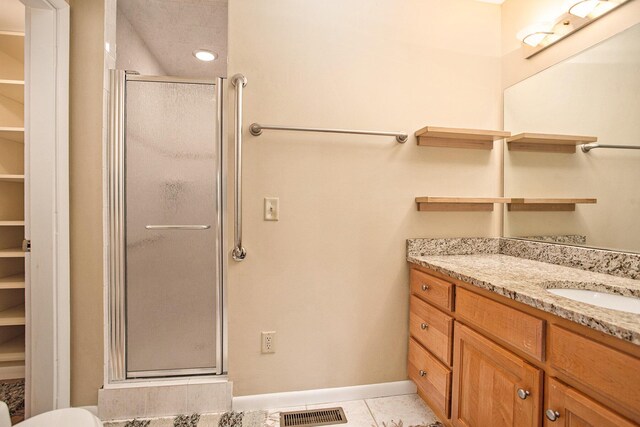2347 W W Dowling Rd, Delton, MI 49046 - bathroom featuring a stall shower, vanity, tile patterned floors, and a spacious closet