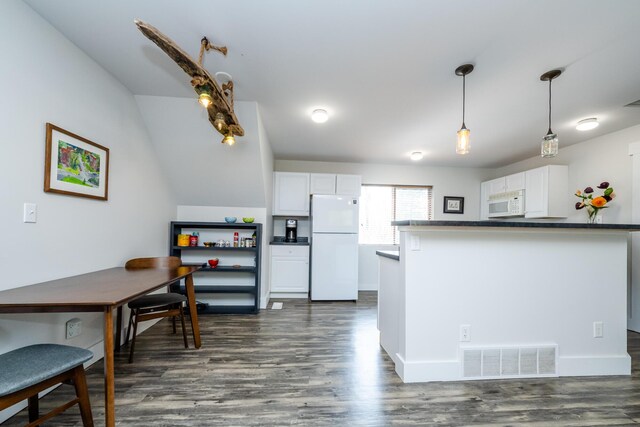10401 Jericho Rd, Bridgman, MI 49106 - kitchen featuring dark countertops, white appliances, white cabinetry, and visible vents