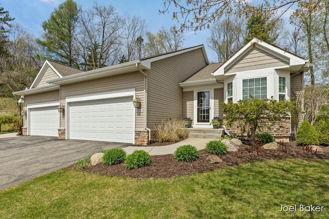 ranch-style home with a garage, a front yard, stone siding, roof with shingles, and driveway