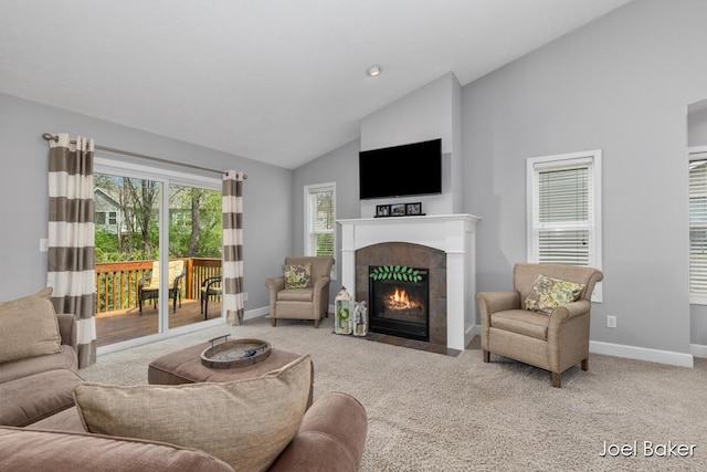 living room with carpet floors, baseboards, high vaulted ceiling, and a fireplace
