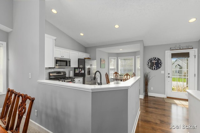 kitchen with white cabinets, recessed lighting, appliances with stainless steel finishes, and a wealth of natural light