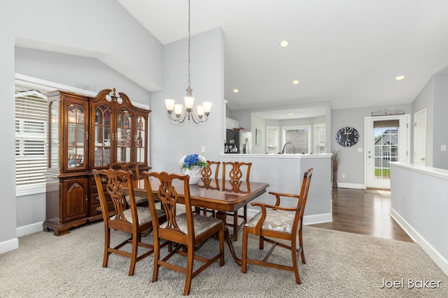dining space featuring light carpet, baseboards, a notable chandelier, recessed lighting, and vaulted ceiling
