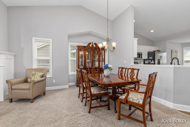 dining space featuring light carpet, a chandelier, recessed lighting, baseboards, and lofted ceiling