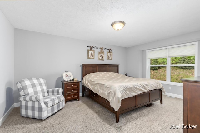 bedroom featuring baseboards and light colored carpet