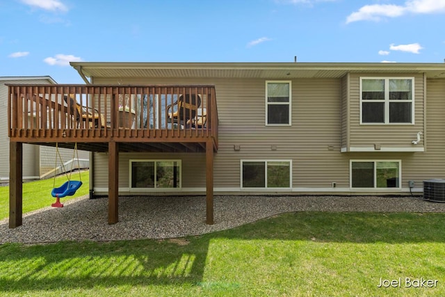 rear view of house with central air condition unit, a deck, and a yard