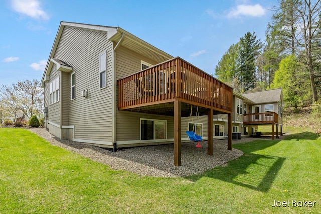 back of property featuring a lawn and a wooden deck