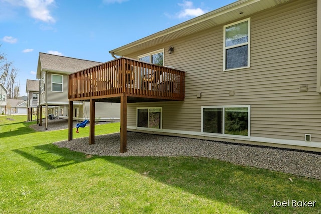 rear view of property with a yard and a deck