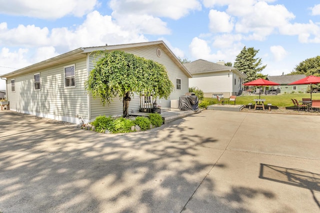 220 Nottingham Dr, Brooklyn, MI 49230 - view of property exterior with a patio area and a lawn