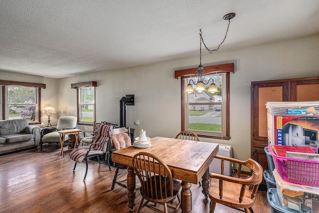 14770 Panu Ave, Kaleva, MI 49645 - dining room with wood finished floors, a textured ceiling, and a chandelier
