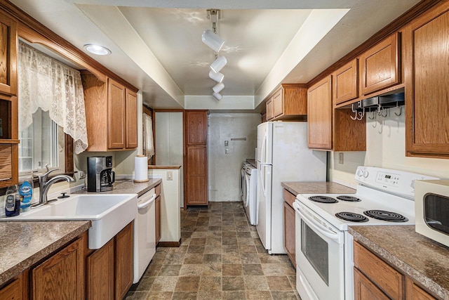 14770 Panu Ave, Kaleva, MI 49645 - kitchen with white appliances, brown cabinets, stone finish flooring, a sink, and under cabinet range hood