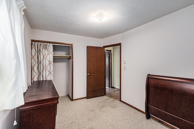 14770 Panu Ave, Kaleva, MI 49645 - unfurnished bedroom featuring carpet, a closet, a textured ceiling, and baseboards