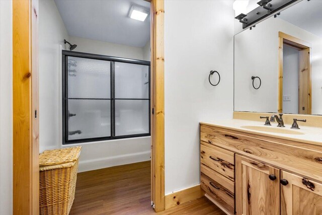 80220 Linden Hills St, Covert, MI 49043 - full bath featuring wood finished floors, enclosed tub / shower combo, vanity, and baseboards