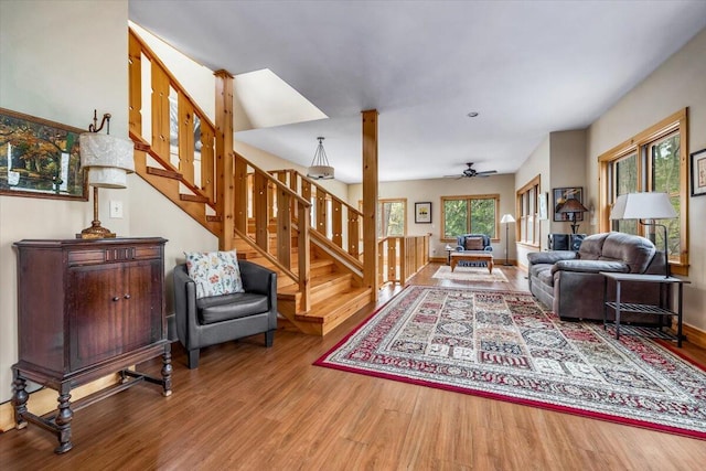 80220 Linden Hills St, Covert, MI 49043 - living room featuring wood finished floors, stairway, ceiling fan, and baseboards