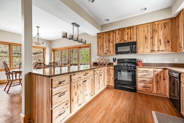 80220 Linden Hills St, Covert, MI 49043 - kitchen featuring black appliances, a peninsula, light wood-type flooring, recessed lighting, and hanging light fixtures