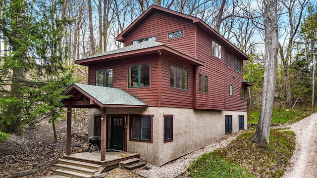 80220 Linden Hills St, Covert, MI 49043 - view of home's exterior featuring roof with shingles and stucco siding