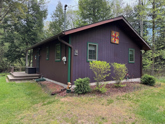 3574 N Comanche Trl, Branch, MI 49402 - view of side of home featuring a lawn and a wooden deck
