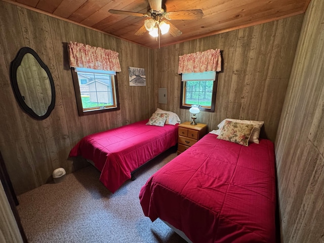 3574 N Comanche Trl, Branch, MI 49402 - carpeted bedroom with multiple windows, wood ceiling, wood walls, and ceiling fan
