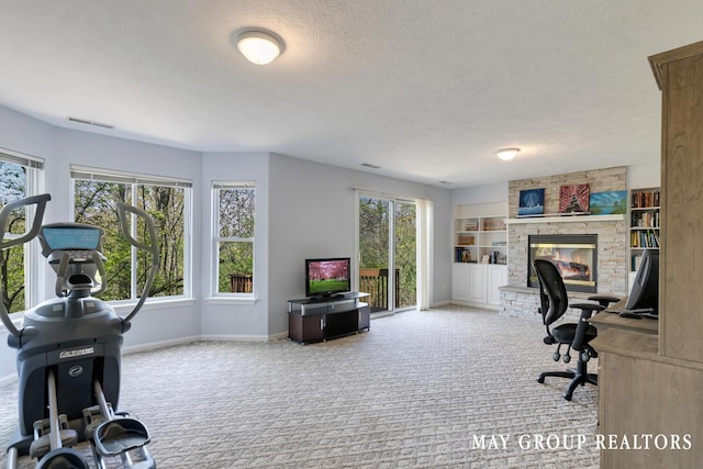 3729 Windshire Dr SE, Grand Rapids, MI 49546 - office with plenty of natural light, carpet flooring, a textured ceiling, a fireplace, and baseboards