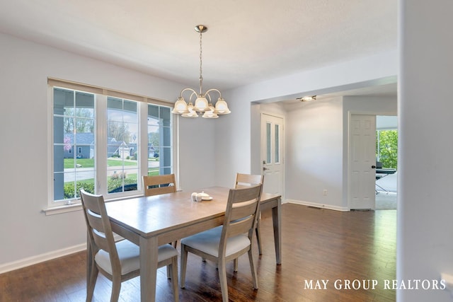 3729 Windshire Dr SE, Grand Rapids, MI 49546 - dining area with a chandelier, baseboards, and dark wood-style floors