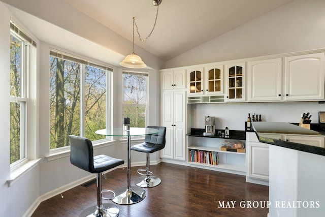 3729 Windshire Dr SE, Grand Rapids, MI 49546 - living area with vaulted ceiling, plenty of natural light, dark wood finished floors, and baseboards