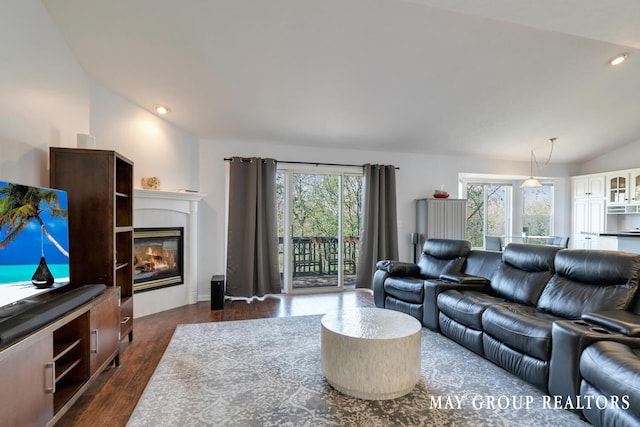 3729 Windshire Dr SE, Grand Rapids, MI 49546 - living area featuring plenty of natural light, dark wood-style flooring, lofted ceiling, a tiled fireplace, and recessed lighting