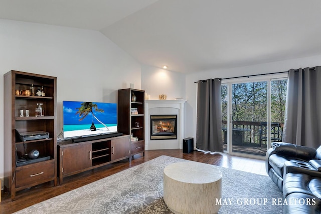 3729 Windshire Dr SE, Grand Rapids, MI 49546 - living area featuring vaulted ceiling, wood finished floors, and a glass covered fireplace