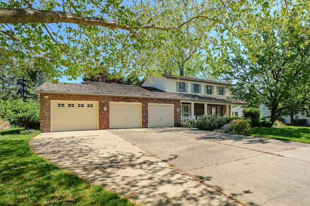 275 S Bluffwood Ter, Saint Joseph, MI 49085 - traditional home with driveway, an attached garage, brick siding, and a front yard