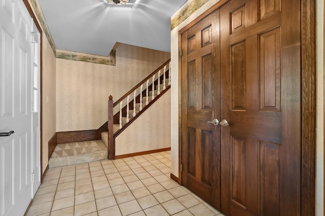 275 S Bluffwood Ter, Saint Joseph, MI 49085 - entryway with stairs, light tile patterned floors, baseboards, and wallpapered walls