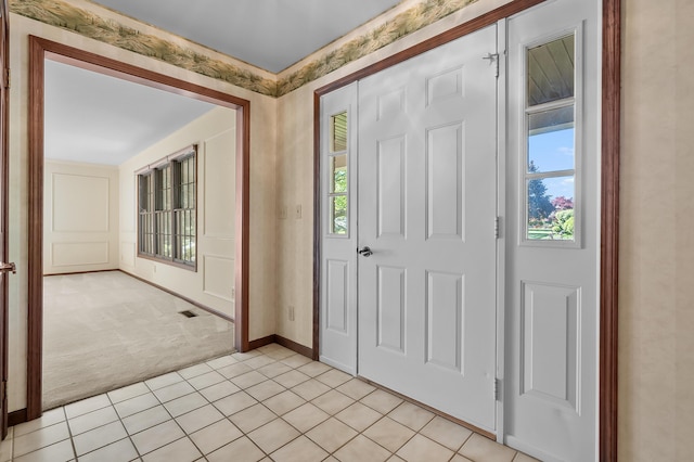 275 S Bluffwood Ter, Saint Joseph, MI 49085 - entrance foyer with light carpet, light tile patterned floors, and baseboards