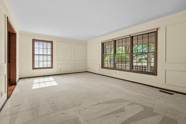275 S Bluffwood Ter, Saint Joseph, MI 49085 - unfurnished bedroom featuring carpet flooring, ornamental molding, a decorative wall, and baseboards