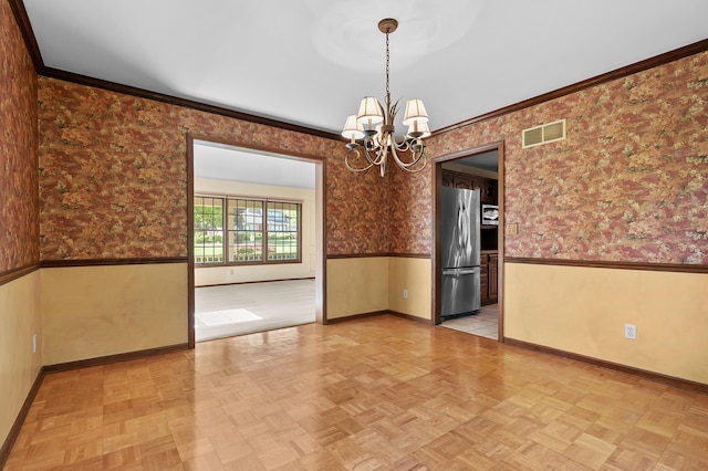 275 S Bluffwood Ter, Saint Joseph, MI 49085 - empty room with a wainscoted wall, baseboards, a chandelier, wallpapered walls, and ornamental molding
