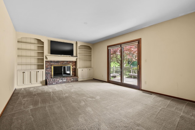 275 S Bluffwood Ter, Saint Joseph, MI 49085 - unfurnished living room with a brick fireplace, carpet floors, baseboards, and built in shelves