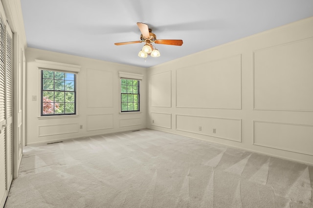 275 S Bluffwood Ter, Saint Joseph, MI 49085 - spare room featuring a decorative wall, light carpet, and a ceiling fan