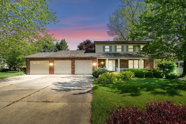 275 S Bluffwood Ter, Saint Joseph, MI 49085 - traditional-style home with concrete driveway, an attached garage, a front yard, and brick siding