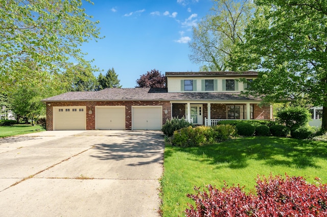 275 S Bluffwood Ter, Saint Joseph, MI 49085 - traditional home with driveway, brick siding, an attached garage, a front yard, and covered porch
