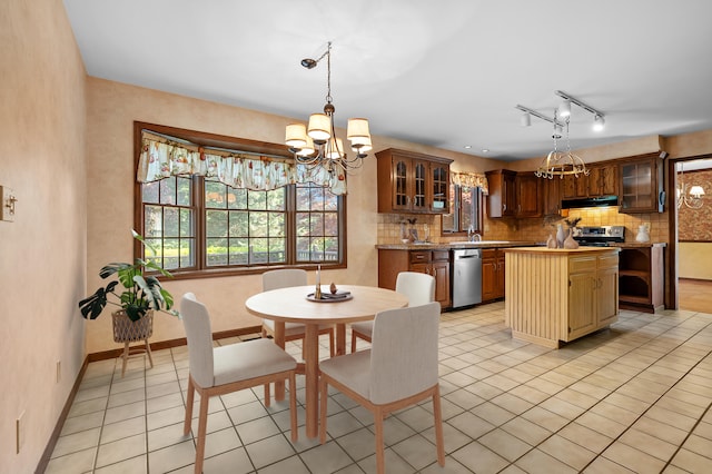 275 S Bluffwood Ter, Saint Joseph, MI 49085 - dining area featuring a chandelier, light tile patterned floors, and baseboards
