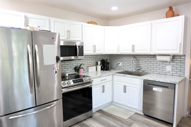 6131 S Mohawk Ave, Ypsilanti, MI 48197 - kitchen featuring stainless steel appliances, a sink, light wood-style flooring, white cabinetry, and recessed lighting