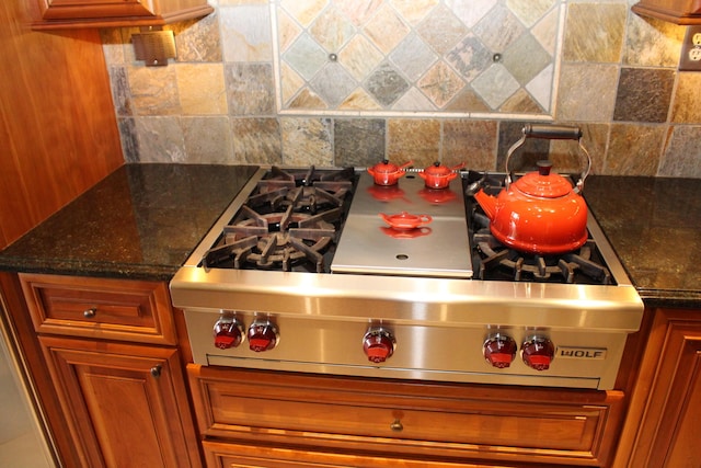 60 Timber Ridge Ct, Milan, MI 48160 - kitchen view of backsplash, brown cabinets, and stainless steel gas cooktop