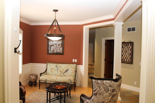 60 Timber Ridge Ct, Milan, MI 48160 - living area with decorative columns, wainscoting, ornamental molding, light wood-style floors, and plenty of natural light