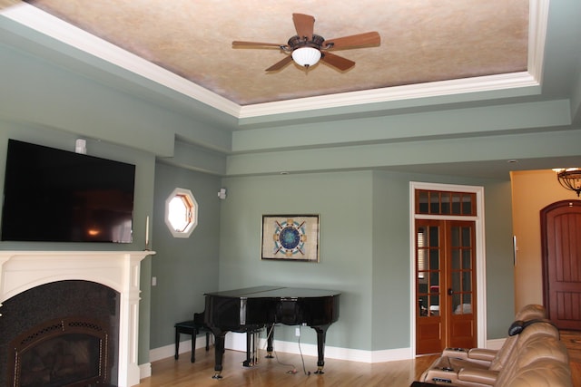 60 Timber Ridge Ct, Milan, MI 48160 - living area featuring a raised ceiling, ceiling fan, wood finished floors, crown molding, and a fireplace